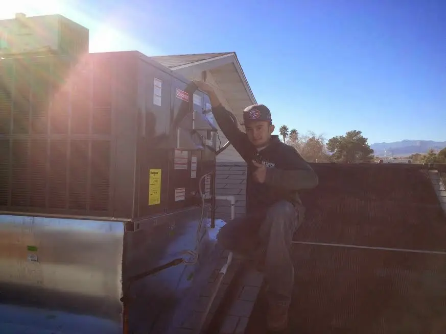 HVAC technician performing HVAC Inspection on a rooftop unit in Dunwoody
